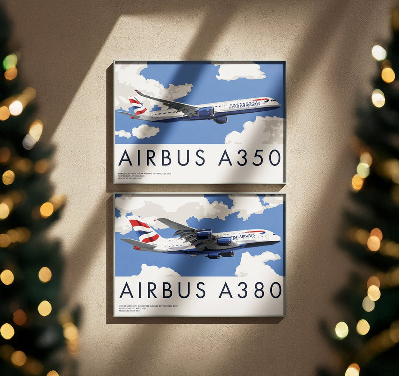 Two framed airliner prints, Airbus A350 and Airbus A380, with Christmas tree lights either side