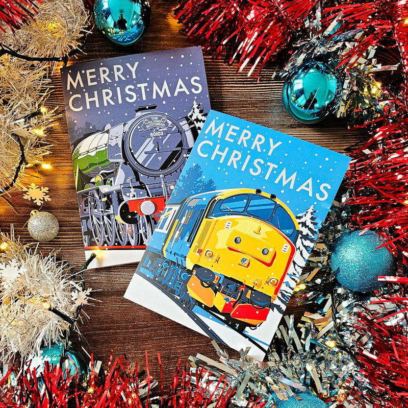 Flying Scotsman and Class 37 Christmas cards lying among tinsel and baubles