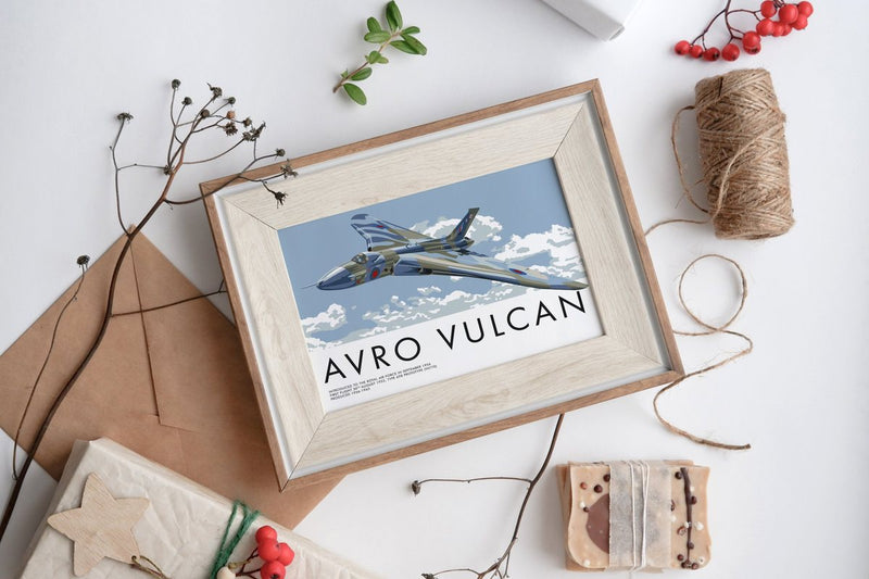 Framed Avro Vulcan print among brown paper, twine and red berries